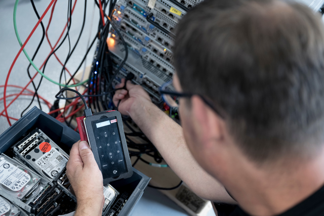 Technician of Nordic Computer testing the IT hardware in testing center