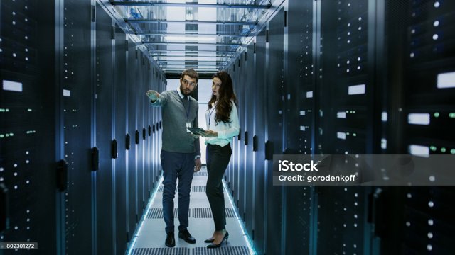 Picture showing two people talking in a storage room