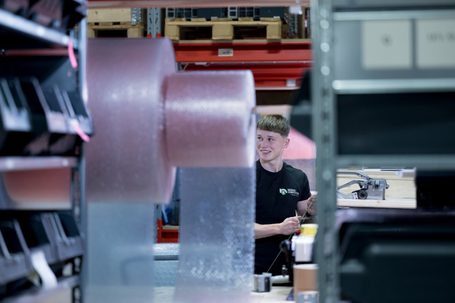 Young emloyee working in the warehouse of Nordic Computer